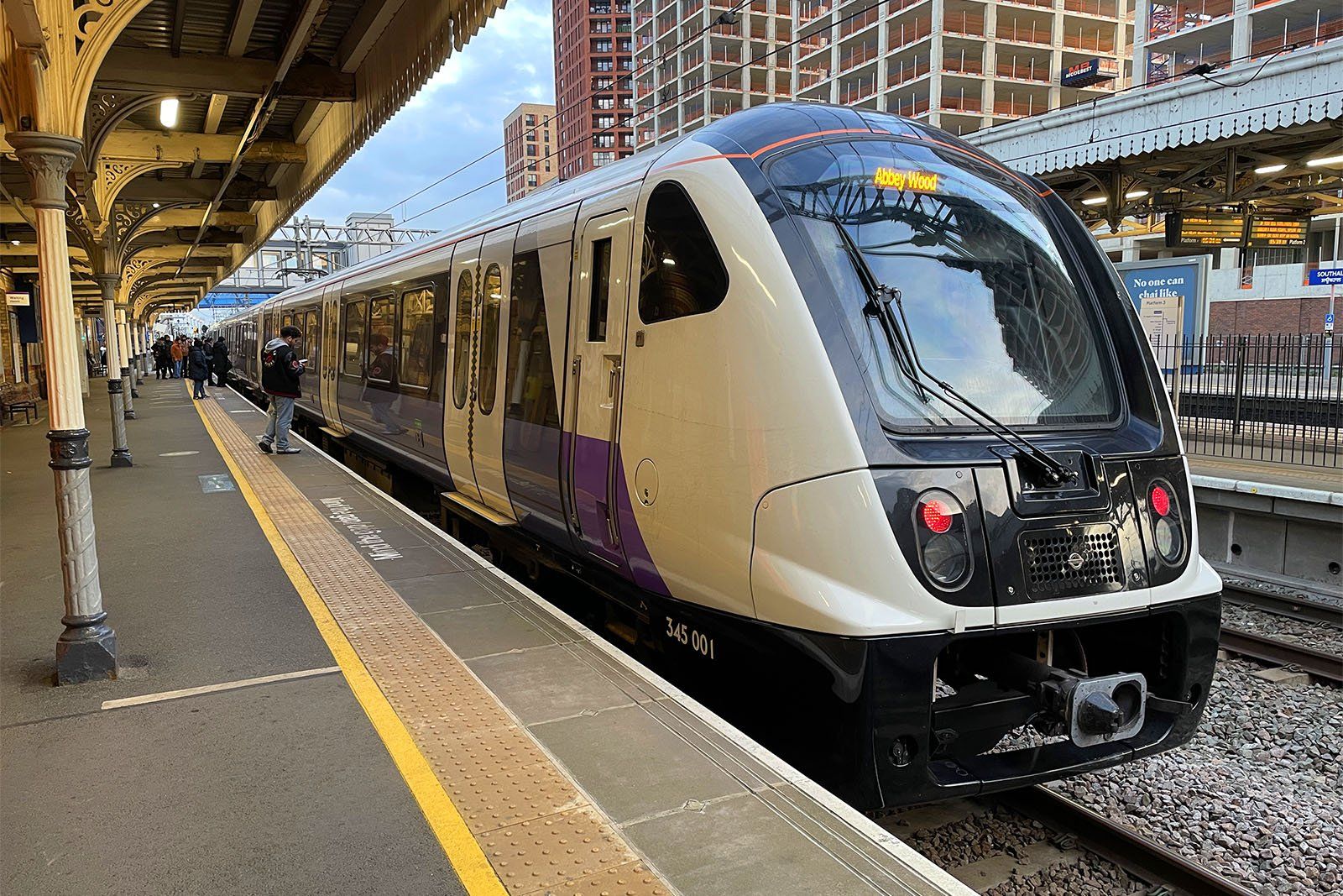 A purple Elizabeth Line Class 345 train at Southall station, working a Heathrow service.