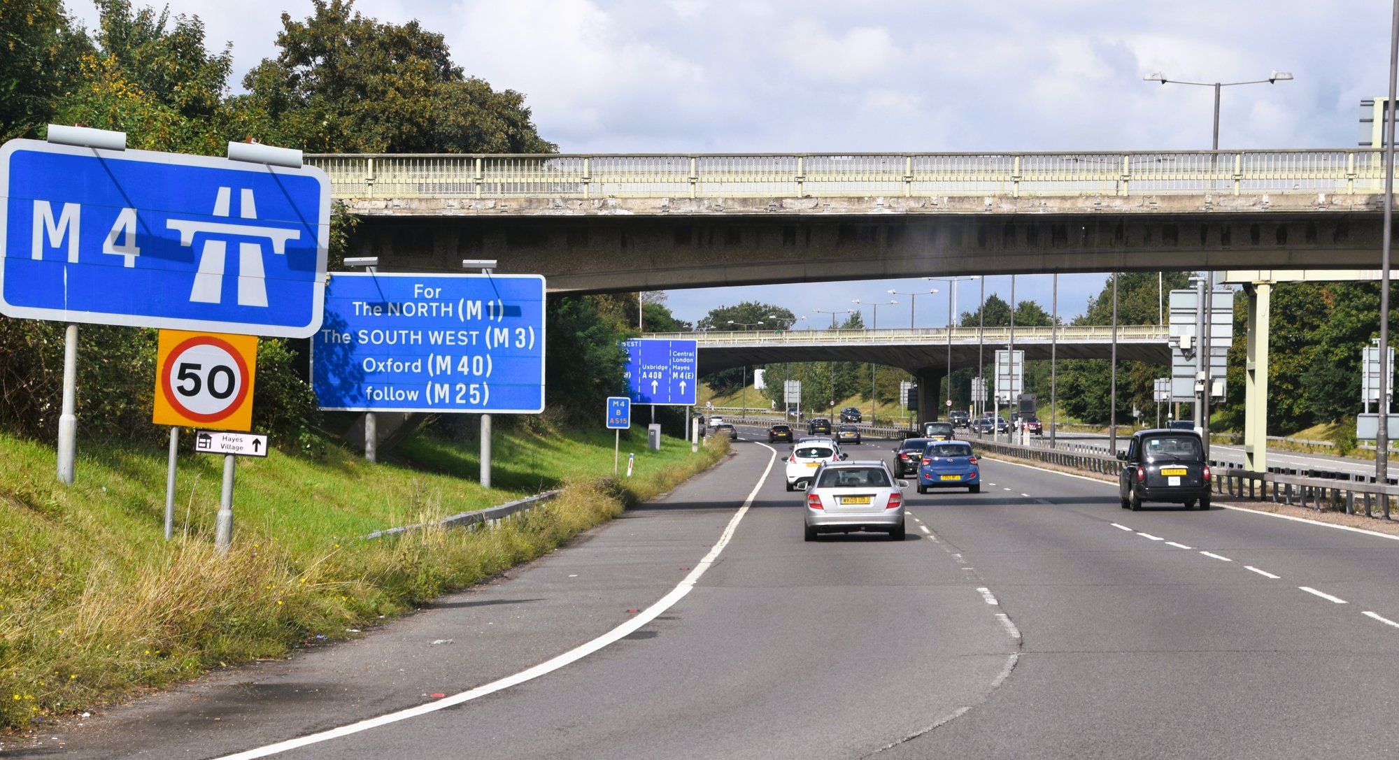The M4 motorway near Heathrow, with a large blue M4 sign and direction signs for the M1, M3, M40, and M25.