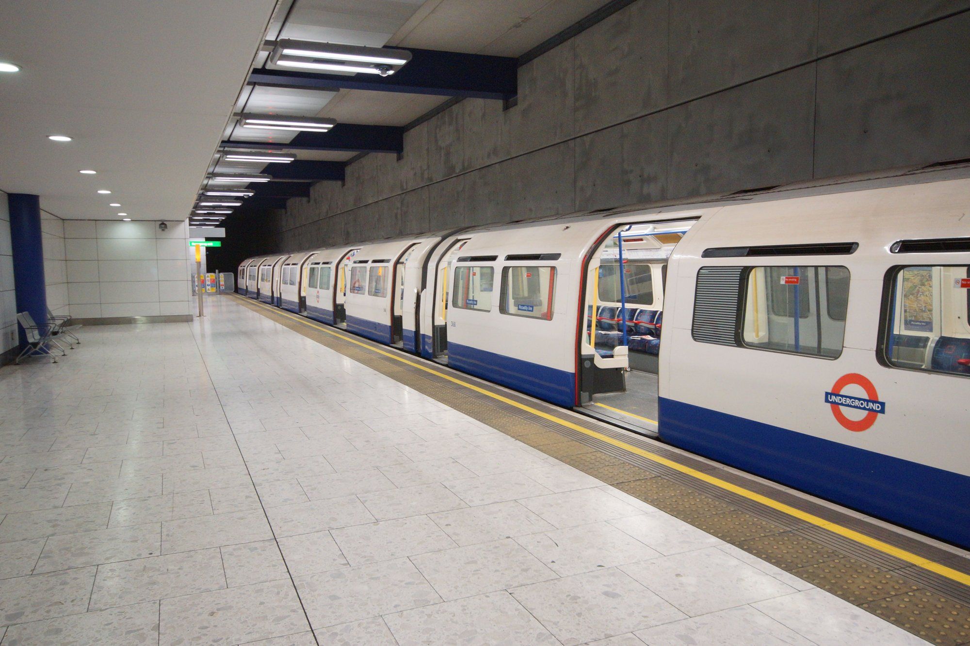 A Piccadilly Line tube train at the Heathrow Terminal 5 Underground platform.